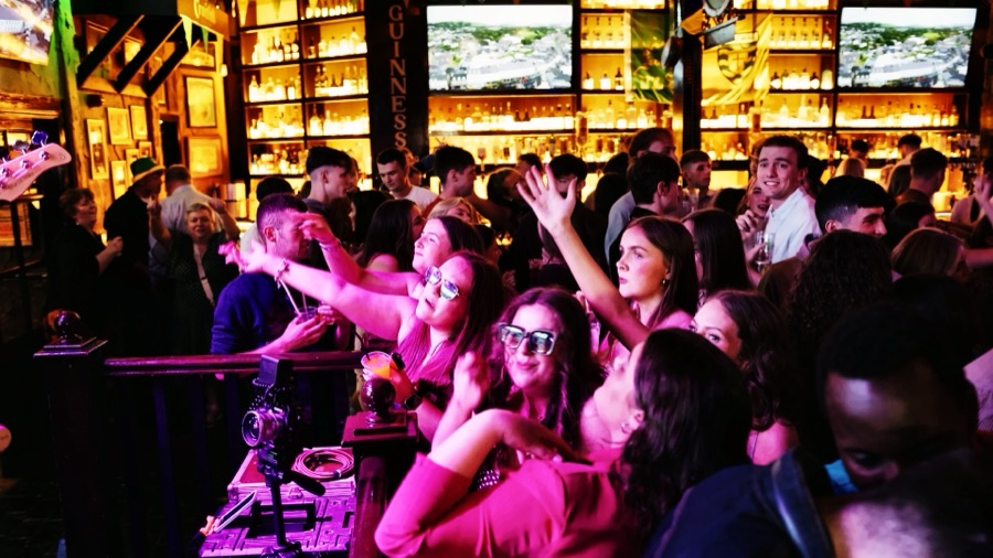 Packed crowd under pink stage lighting